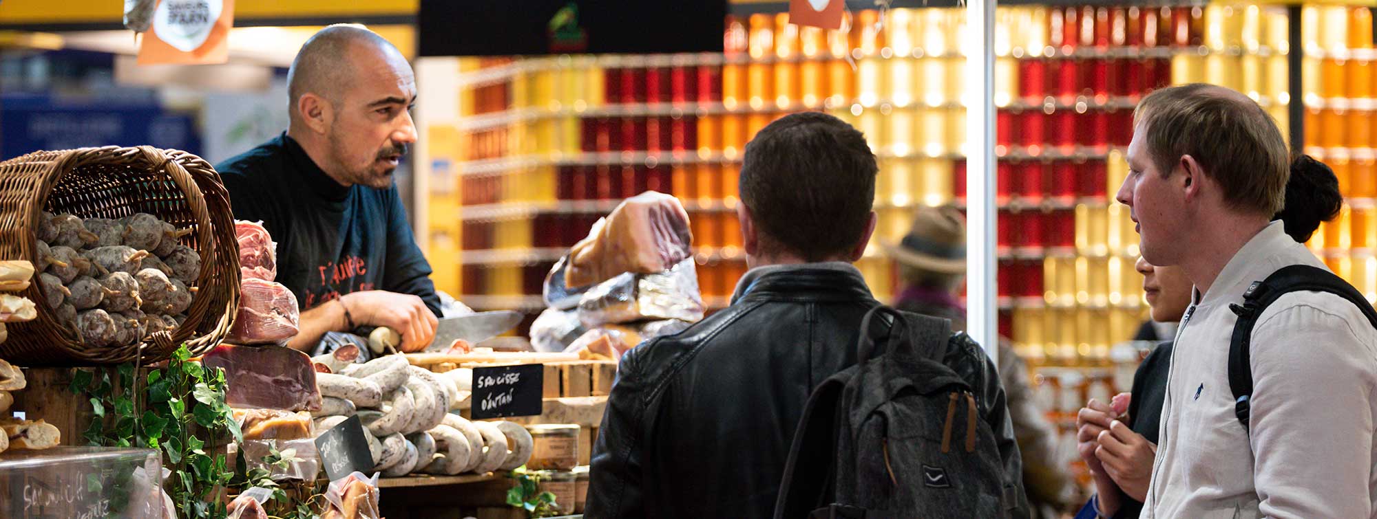 Exhibitor behind his delicatessen stand