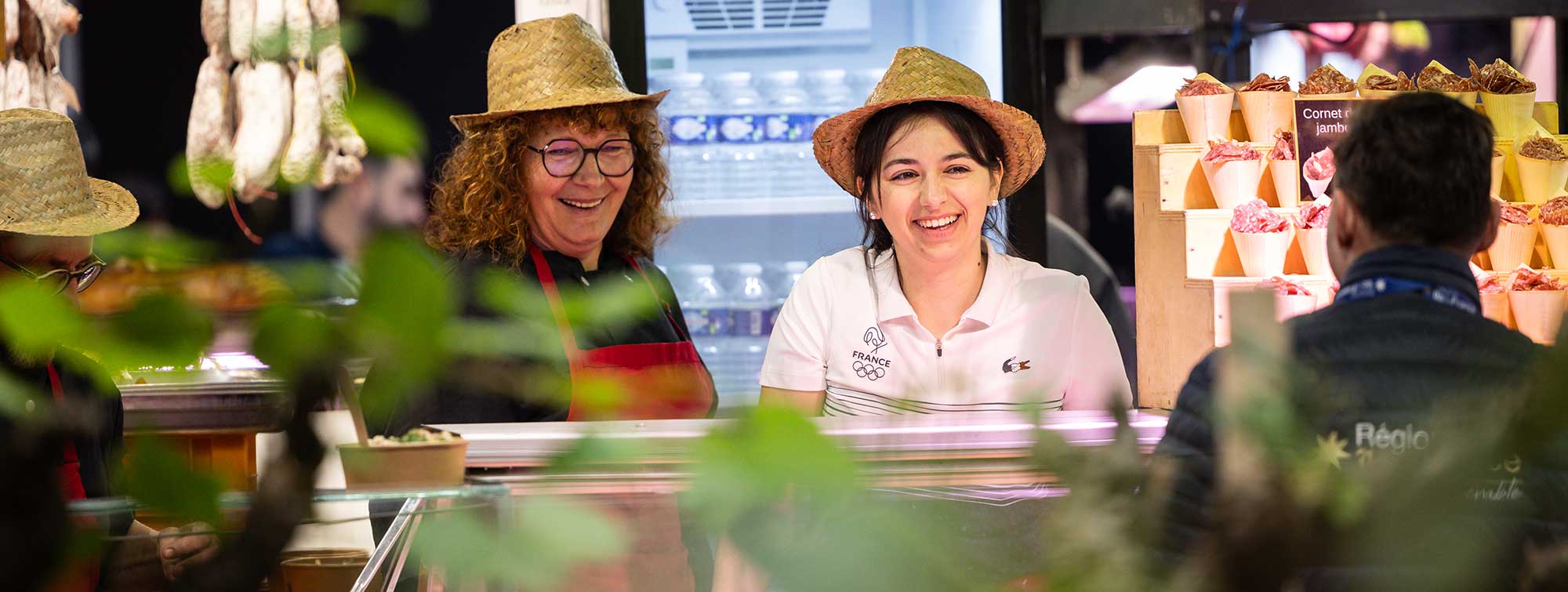 Two women exhibitors talking to a visitor