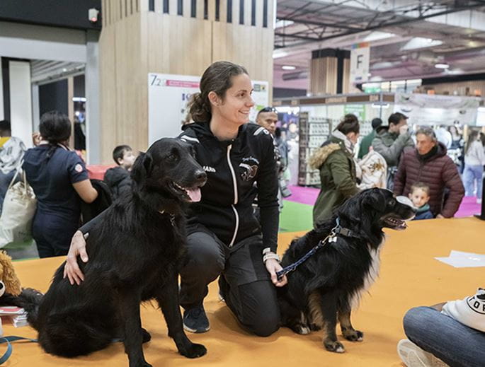 Woman surrounded by two dogs