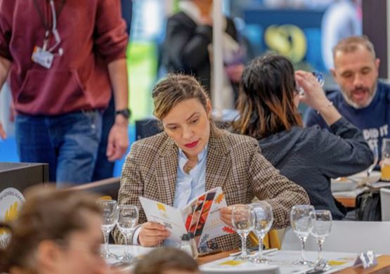 woman checking the menu of the restaurant "Les Médaillés" of CGA